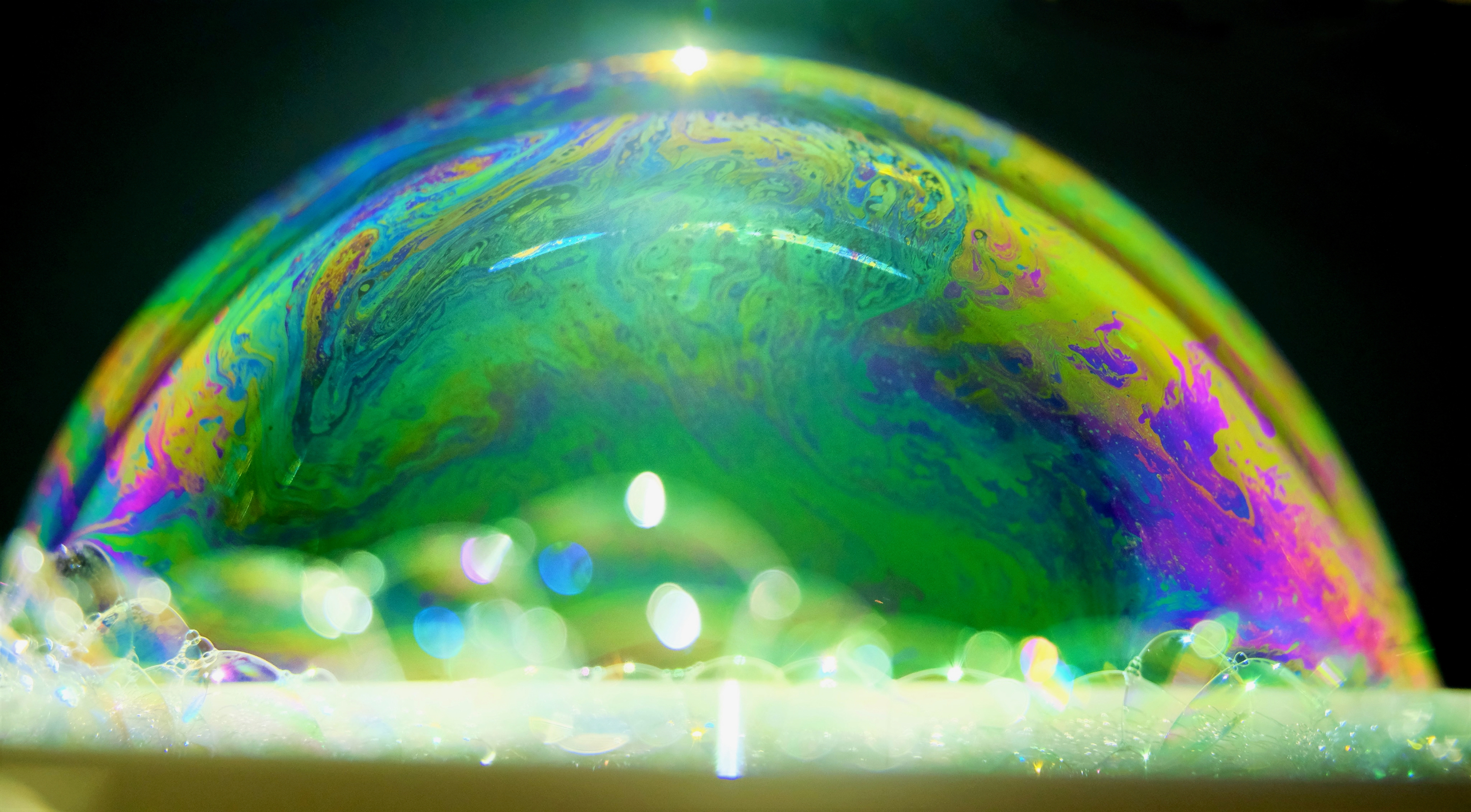 The chaotic patterns in a soap film are an example two-dimensional turbulence. This bubble was created using water and a weak dilution of detergent and sugar. In the thin wall of the bubble, vortex stretching is restricted, enstrophy is conserved, and different inertial range scalings occur than in 3D turbulence.
